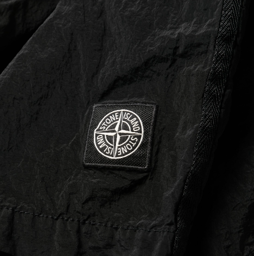 STONE ISLAND LOGO PATCH SWIM SHORTS IN BLACK